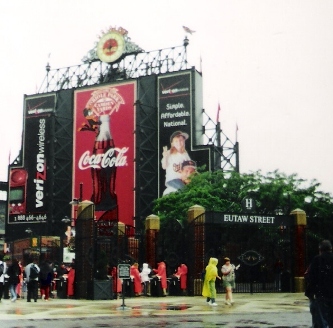 Outside of Camden Yards people in rain gear