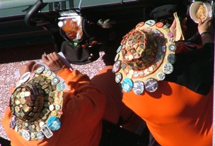 2 ladies with hats with buttons on them