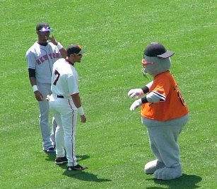 Giants and Mets player with the Giants mascot